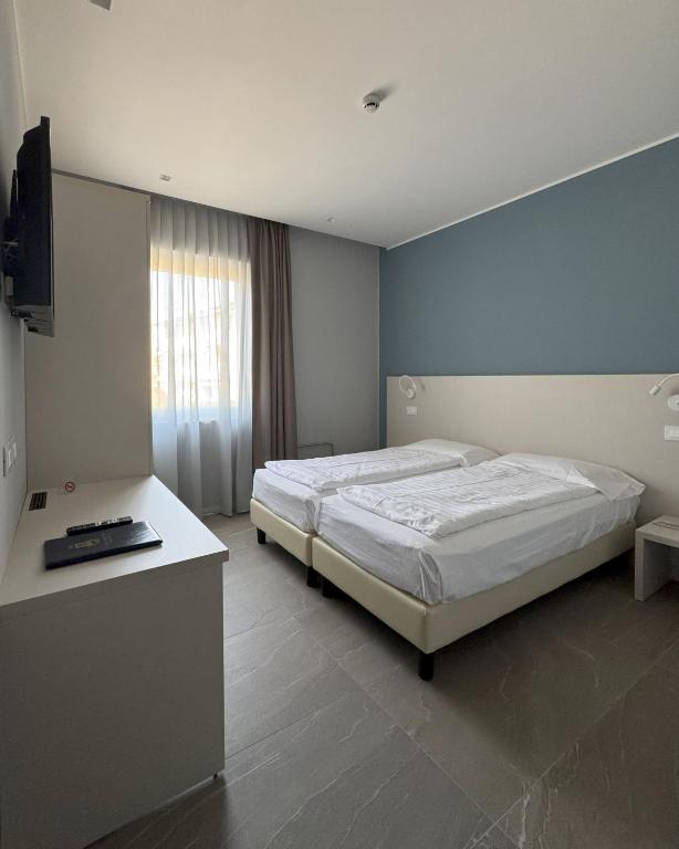 Postel nebo postele na pokoji v ubytování Hotel Paradiso