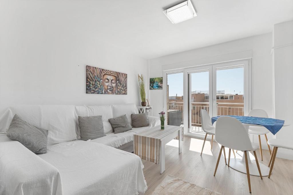a white living room with a couch and a table at Antogil-mata1 in La Mata