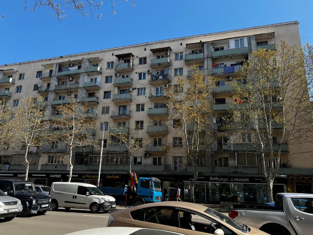 a large building with cars parked in front of it at Casa de Sogno in Tbilisi City