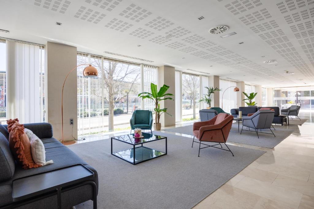 a living room with a couch and chairs and tables at Daniya Alicante in Alicante