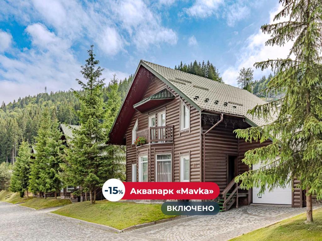a log house in the woods with a garage at Bukovel Hotel in Bukovel