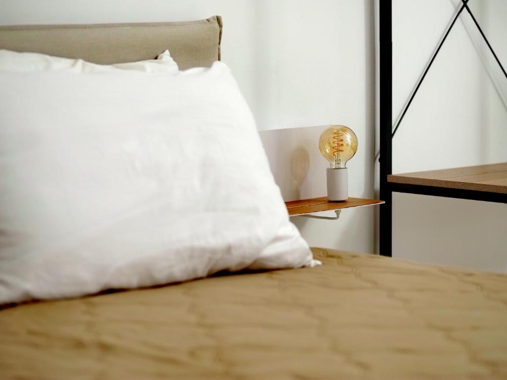 a bed with a pillow and a lamp on it at C'era una volta in Modugno