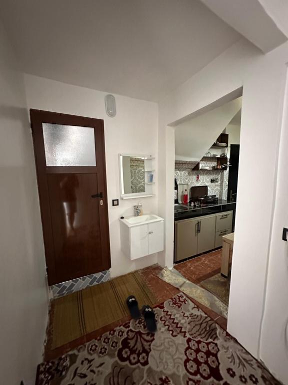 a room with a door and a sink and a kitchen at Taghazout Hostel in Oulad Akkou
