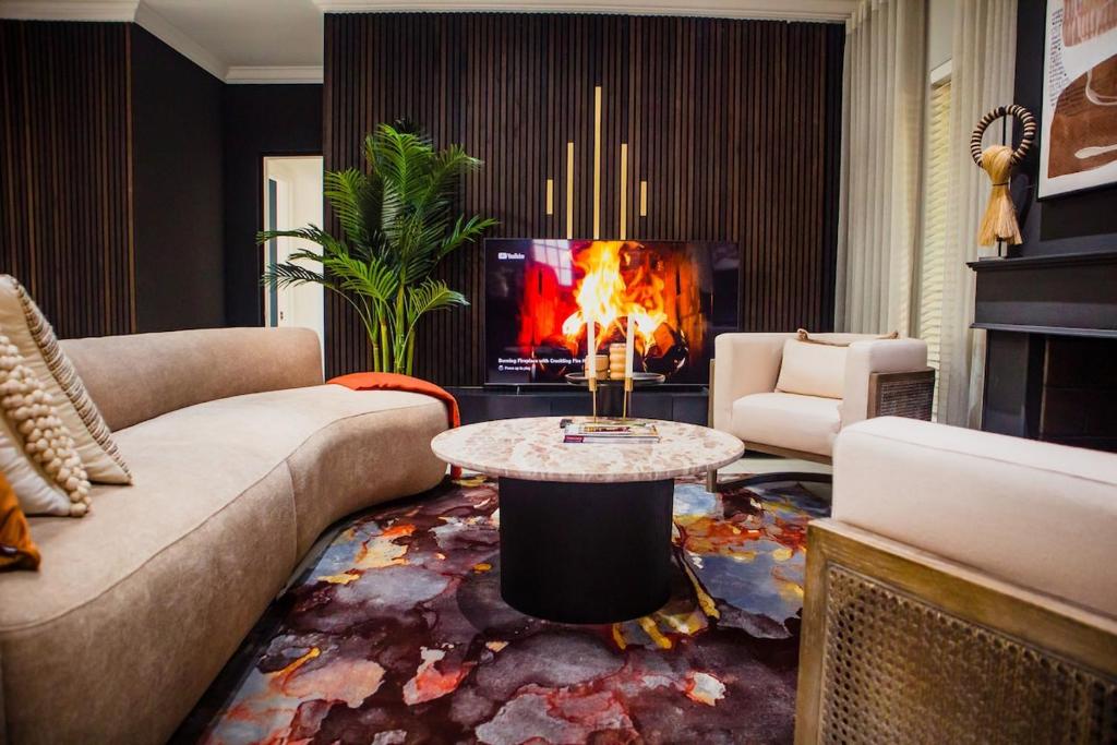 a living room with a couch and a table at 5 On Dana in Gqeberha
