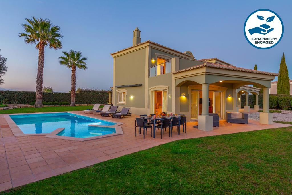 a villa with a swimming pool and a house at Villa Bliss by Algarve Vacation in Praia do Carvoeiro