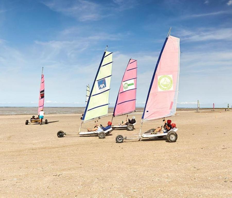 a group of sailboats on a sandy beach at Le cottage de Zoé in Le Vivier-sur-Mer