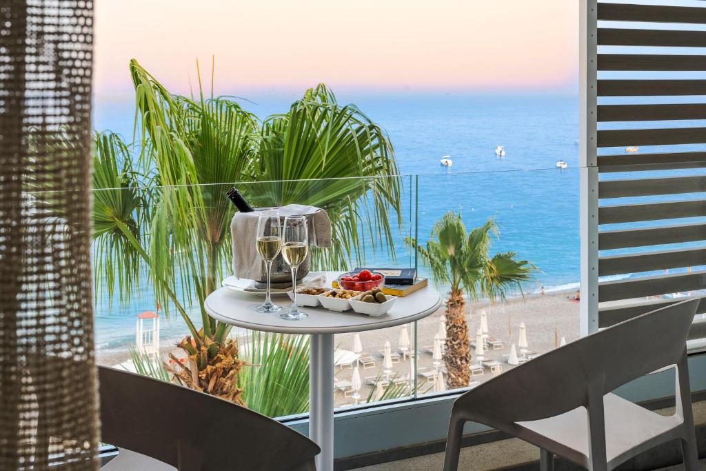 a plate of food on a table in front of a beach at Albatros Beach Hotel in Letojanni