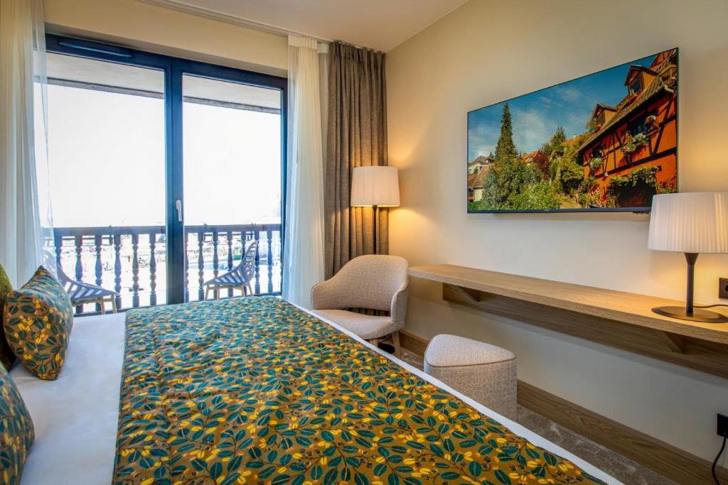 Postel nebo postele na pokoji v ubytování Hôtel Terra Vinum
