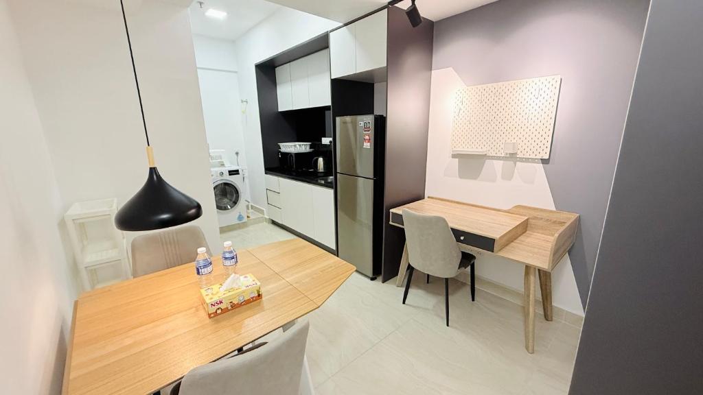 a kitchen and dining room with a table and chairs at Colony Service Suites Kuala Lumpur in Kuala Lumpur