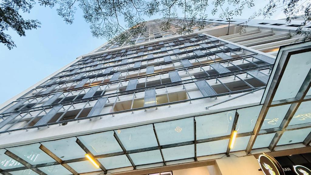 a tall building with lots of windows at Colony Service Suites Kuala Lumpur in Kuala Lumpur