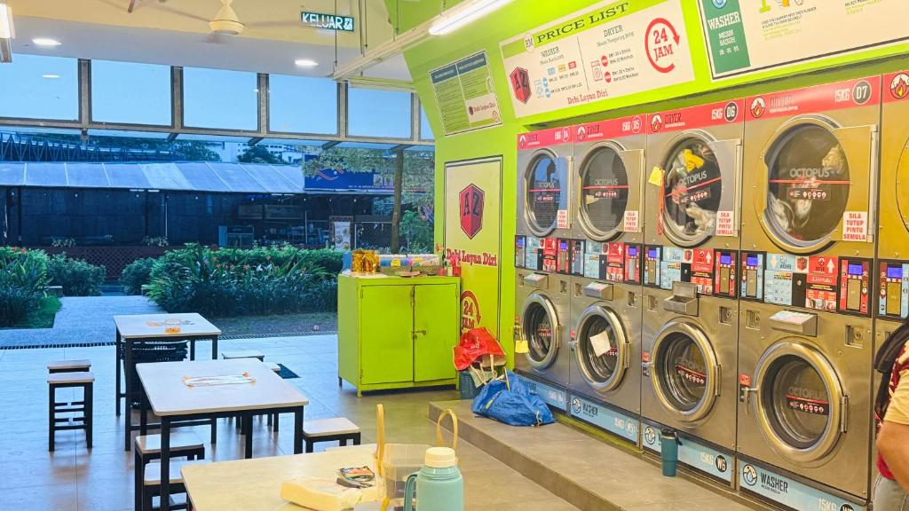 a store with three washing machines in a room at Colony Service Suites Kuala Lumpur in Kuala Lumpur