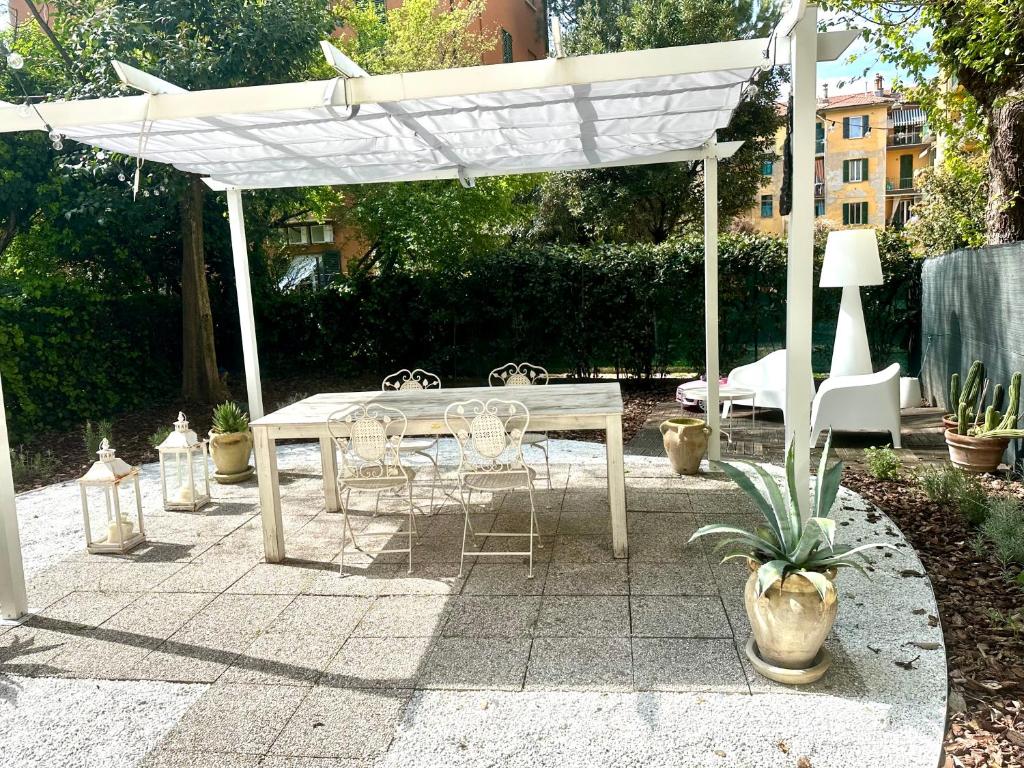 a wooden table and chairs under a white canopy at Casa Sofia in Bologna