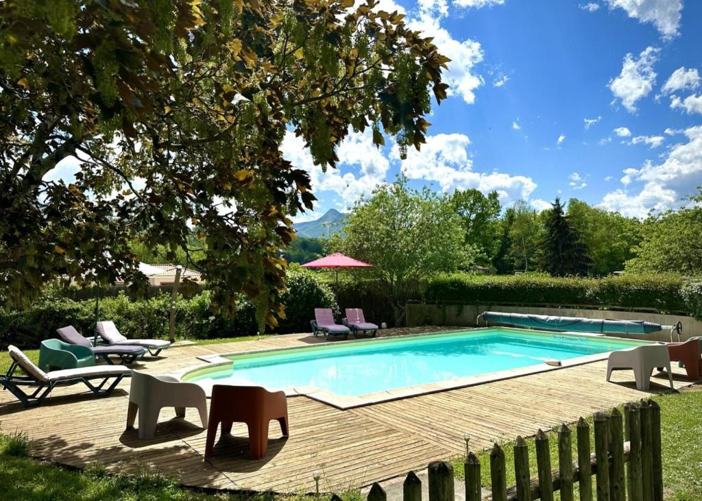 a swimming pool in a yard with chairs and a table at Le clos saint-paul - nature in Estadens