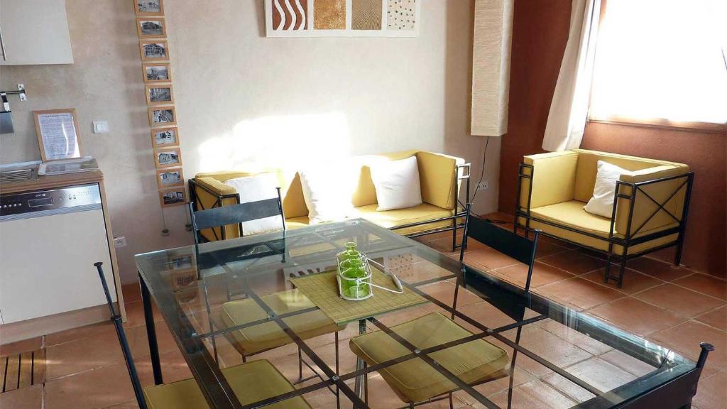 a living room with two chairs and a glass table at Gîte Baugnac N°2 in Lavalette