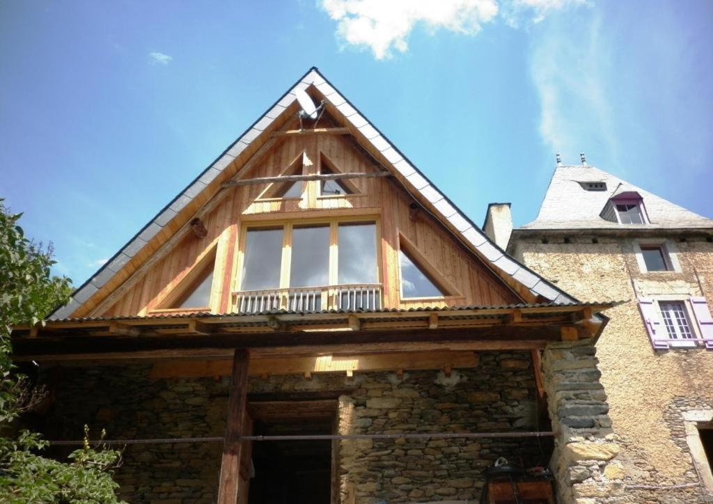 a house with a roof with a window on it at La grange de martine in Saccourvielle
