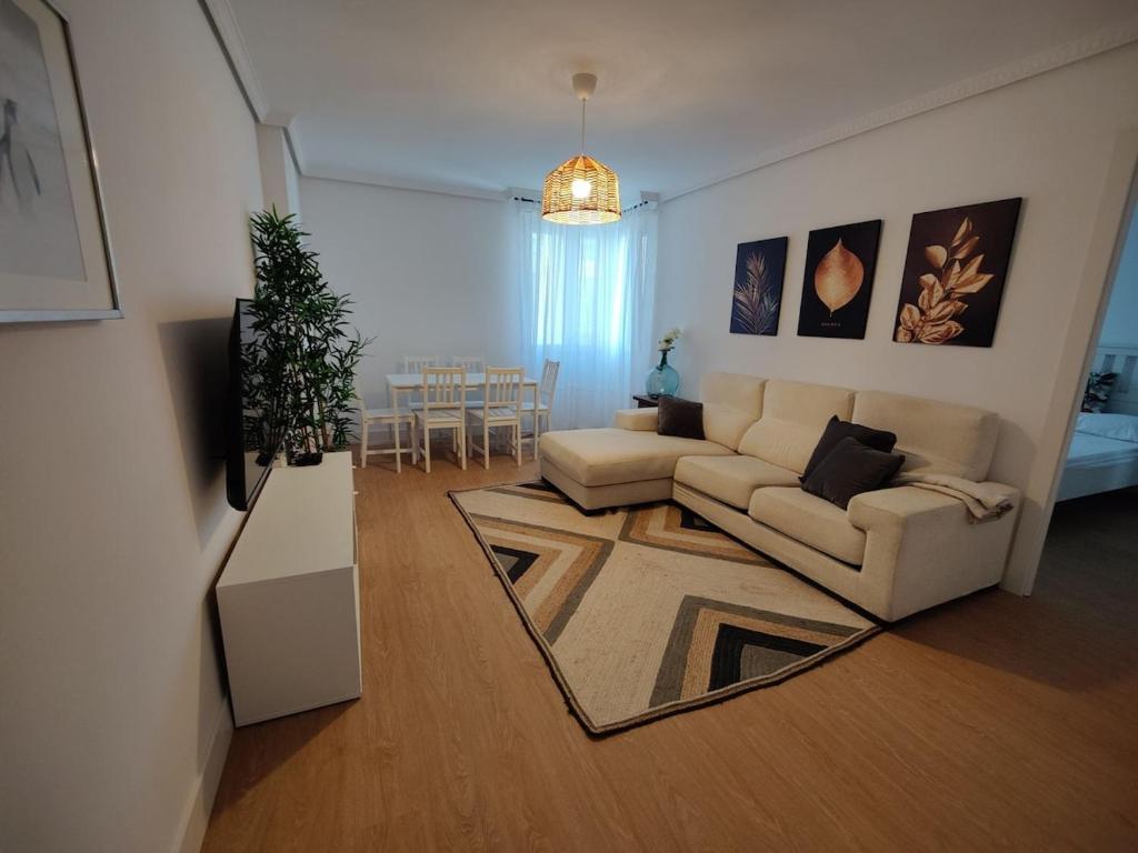a living room with a couch and a table at Apartamento La Ballena 2 - Las Huertas in Santoña