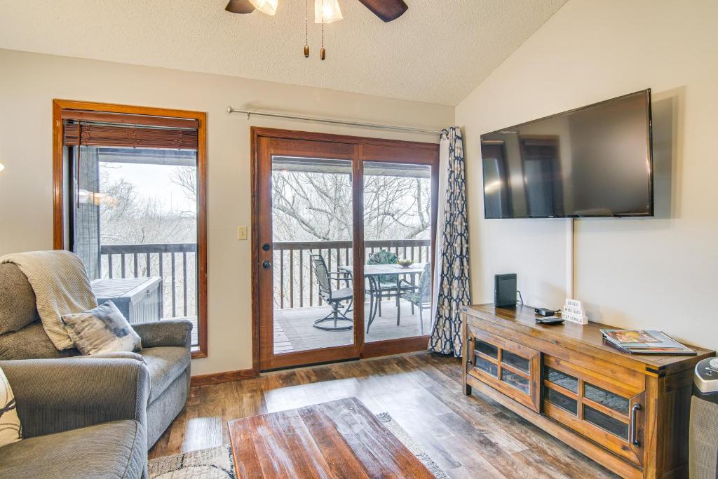 a living room with a couch and a television at Family-Friendly Condo 1 Mi to Silver Dollar City! in Branson West