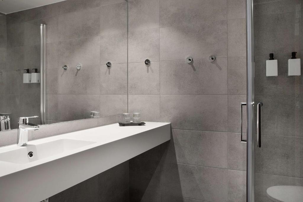 a bathroom with a sink and a shower at Scandic Hell in Hell