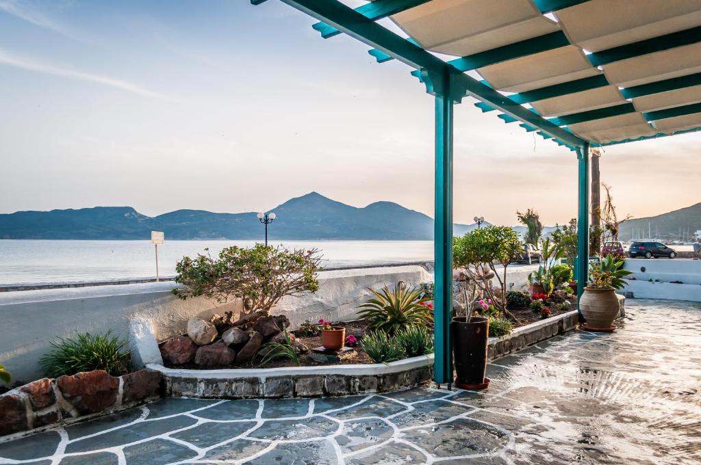a patio with plants and a view of the water at Seaside Apartments in Adamantas