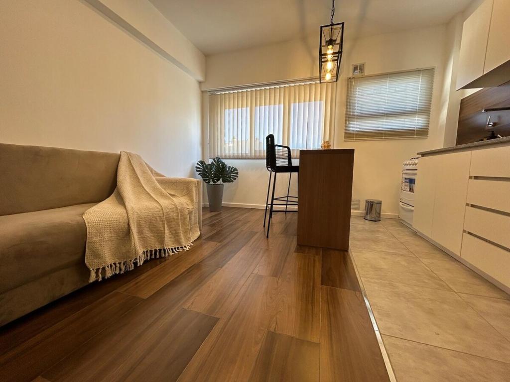a living room with a couch and a table at Depto Colon in Mar del Plata