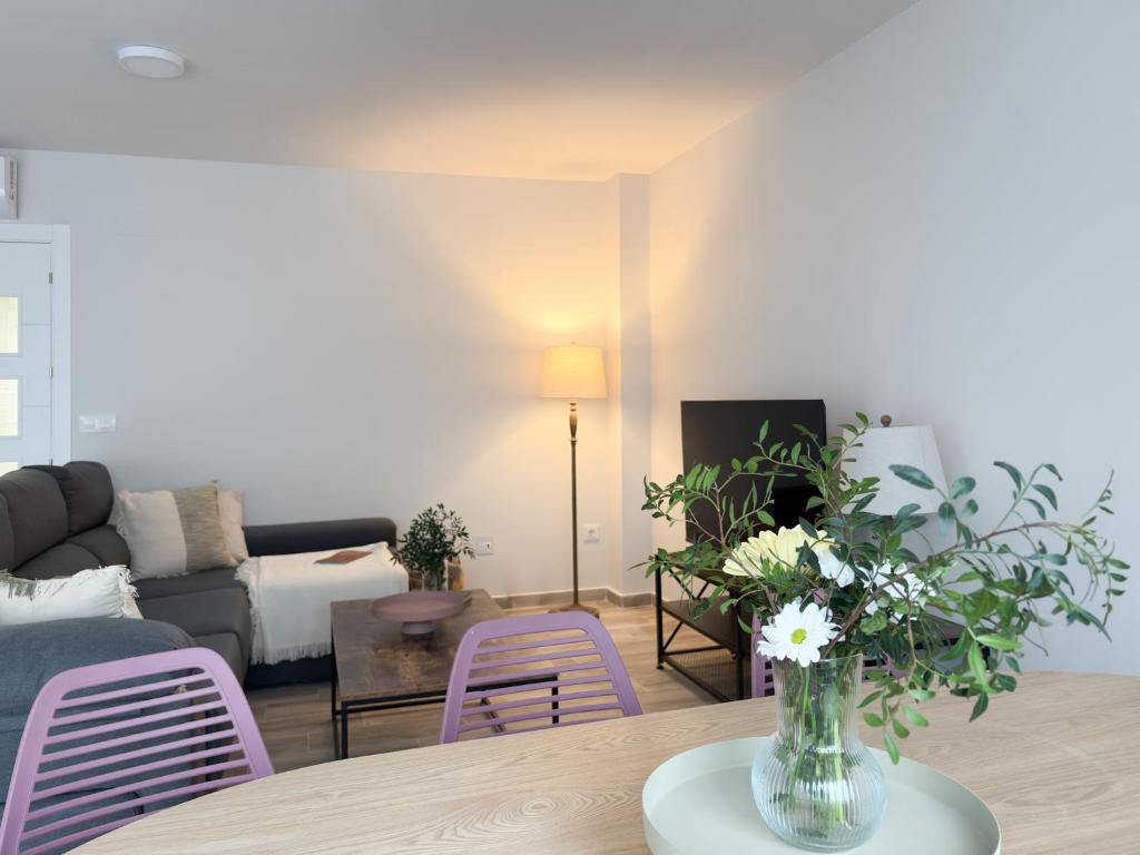 a living room with a vase of flowers on a table at ChillaHomes 102 in Candeleda