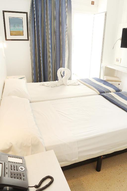 Postel nebo postele na pokoji v ubytování Hotel Cassandra