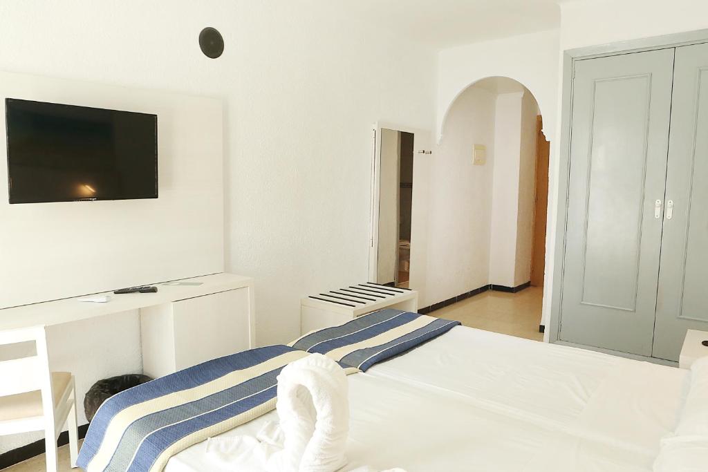 Postel nebo postele na pokoji v ubytování Hotel Cassandra
