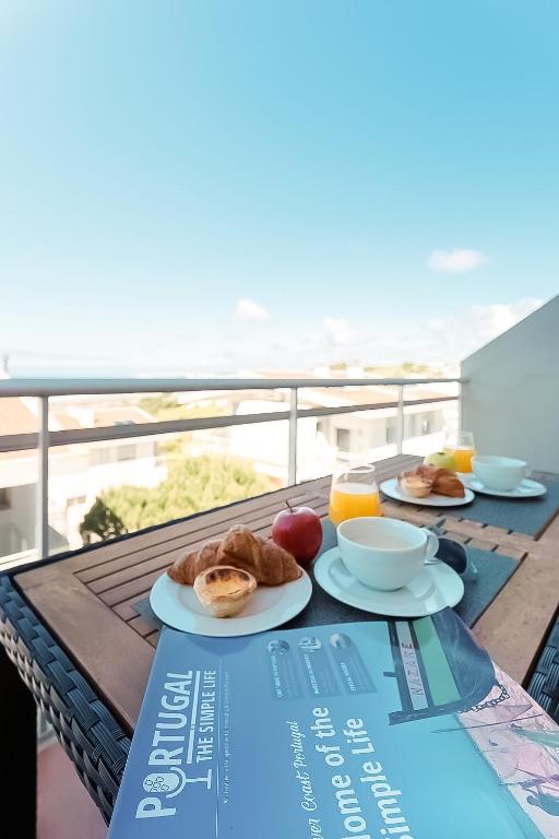 a table with two plates of breakfast food on a balcony at Serene View - By SCH in Alvados