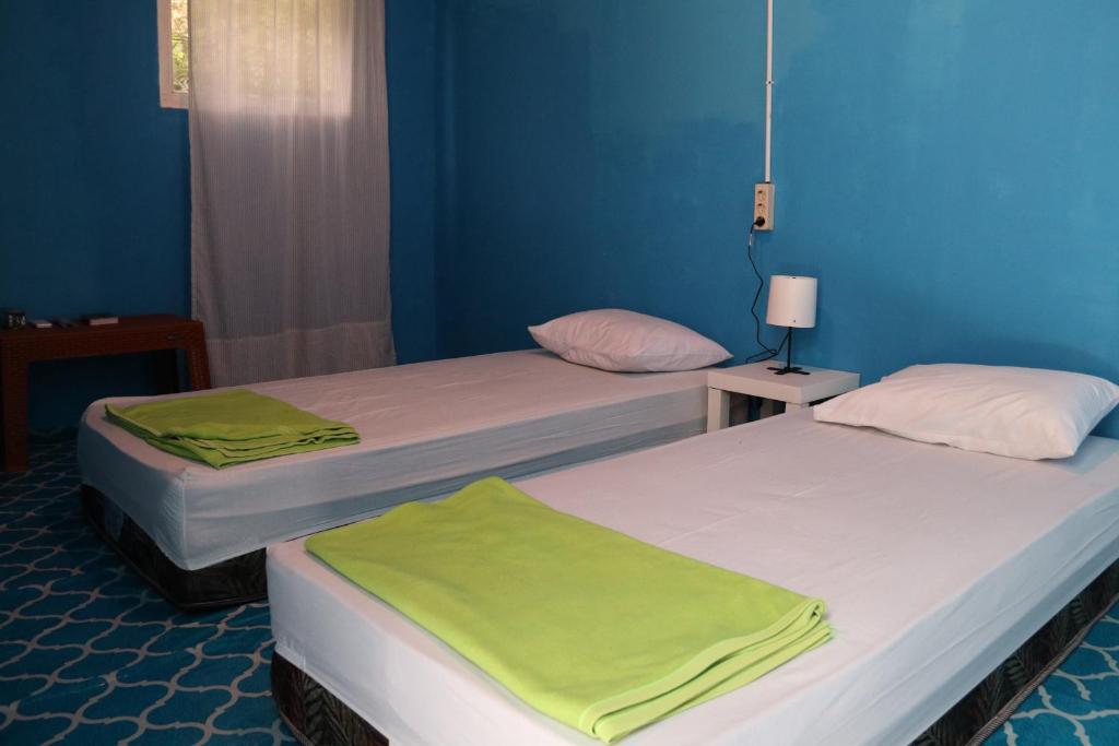 Postel nebo postele na pokoji v ubytování Tanjong Tinggi Cottage