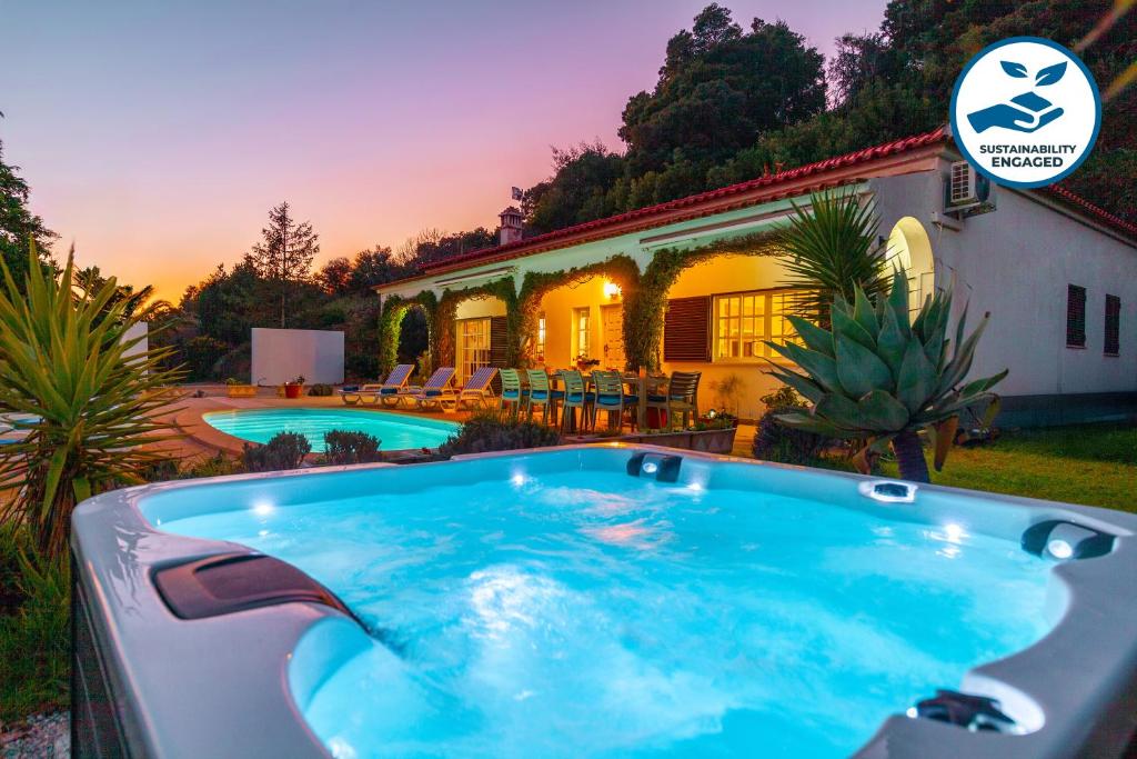 a swimming pool in front of a house at Villa Monchique Royal by Algarve Vacation in Monchique