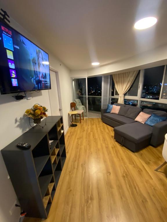 a living room with a couch and a flat screen tv at Vista piso 24 in Lima