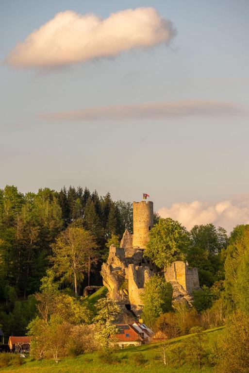 an old stone house on a hill with trees at Hotel reSTART Superior in Jičín