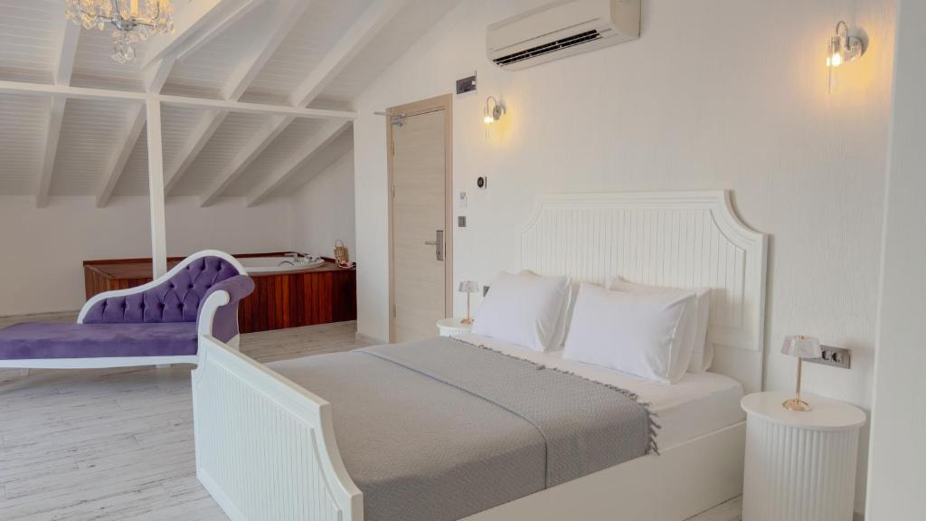 Postel nebo postele na pokoji v ubytování Cunda Nisa Otel