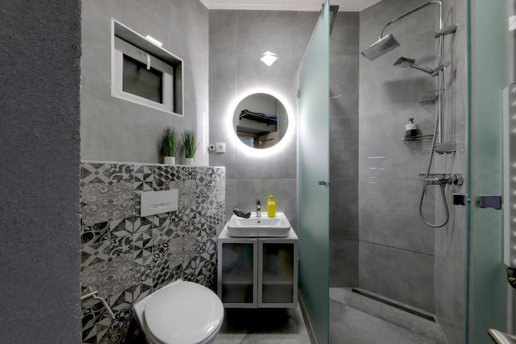 a bathroom with a toilet and a sink and a shower at Lovely 2-bedroom apartment in centre of Bratislava in Bratislava