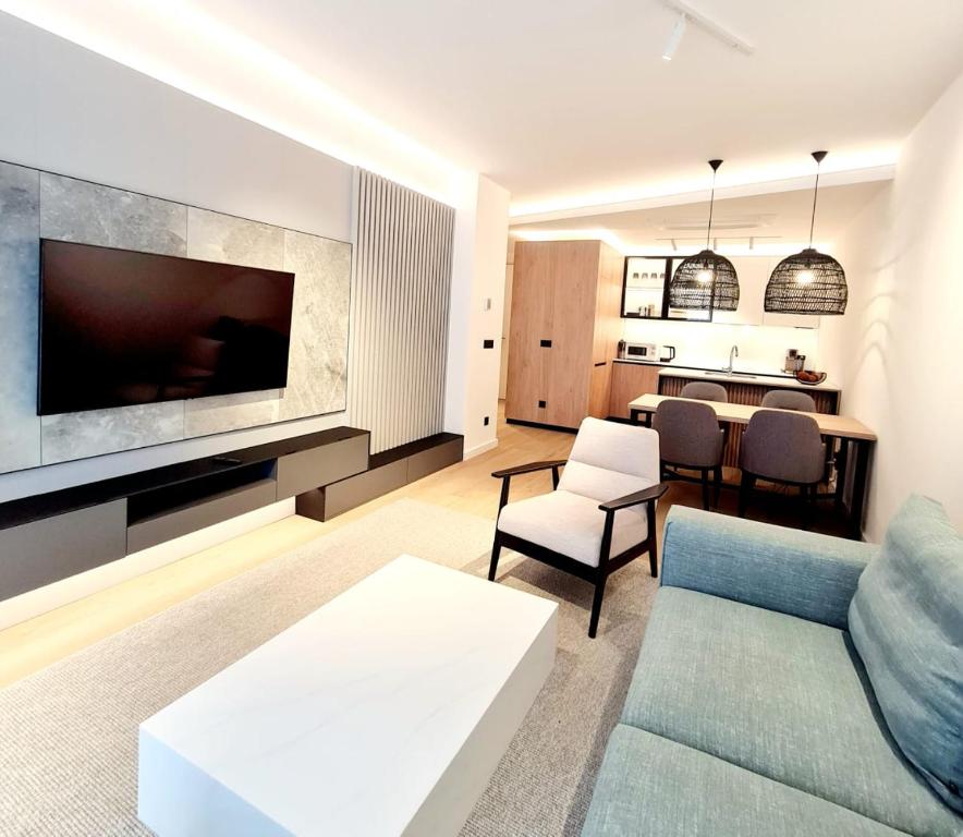 a living room with a couch and a tv at Air Onia in Budva