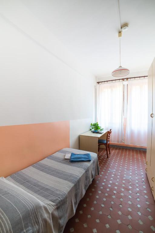 Postel nebo postele na pokoji v ubytování Ostello Domus Civica