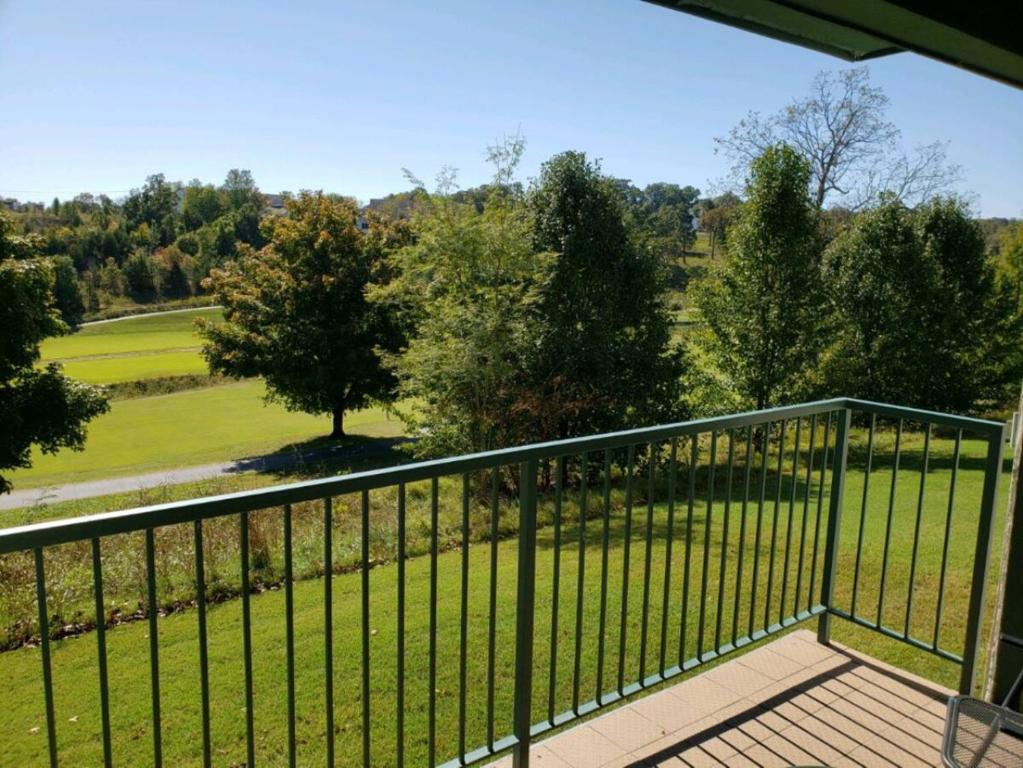 a balcony with a view of a golf course at The Greens at Thousand Hills in Branson