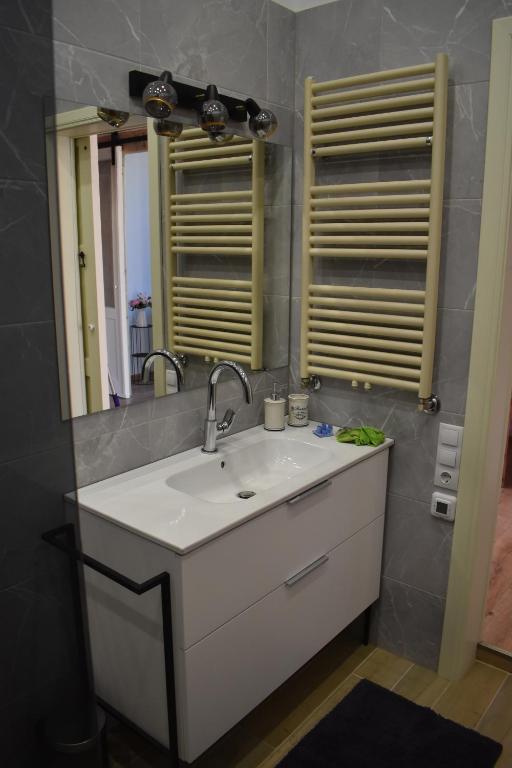 a bathroom with a sink and a mirror at Sunset Lovers Residence in Liepāja