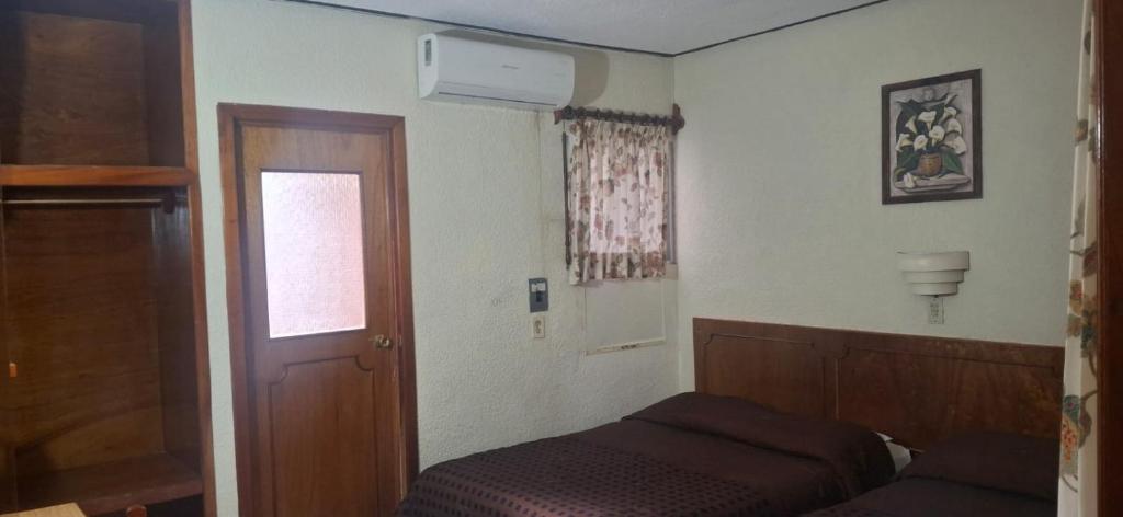 Postel nebo postele na pokoji v ubytování Hotel María de la Luz