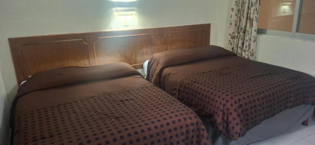Postel nebo postele na pokoji v ubytování Hotel María de la Luz