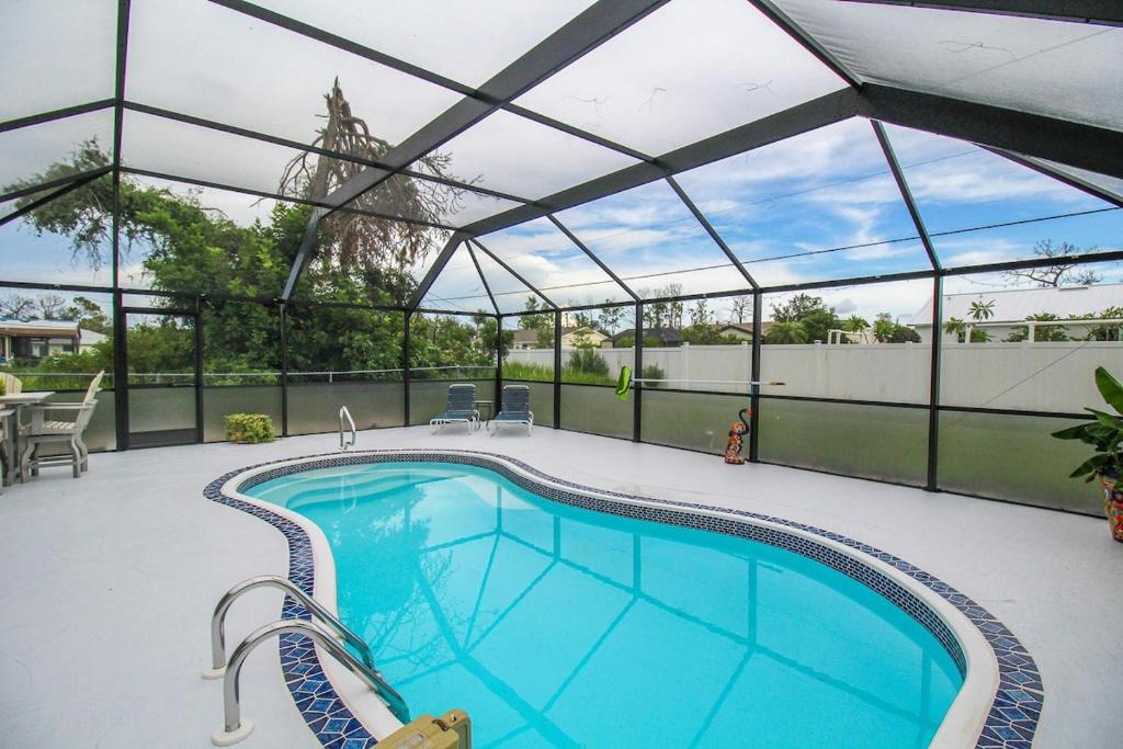 a large swimming pool with a retractable roof at Relaxing pool home in Englewood - Awake Zone in Englewood