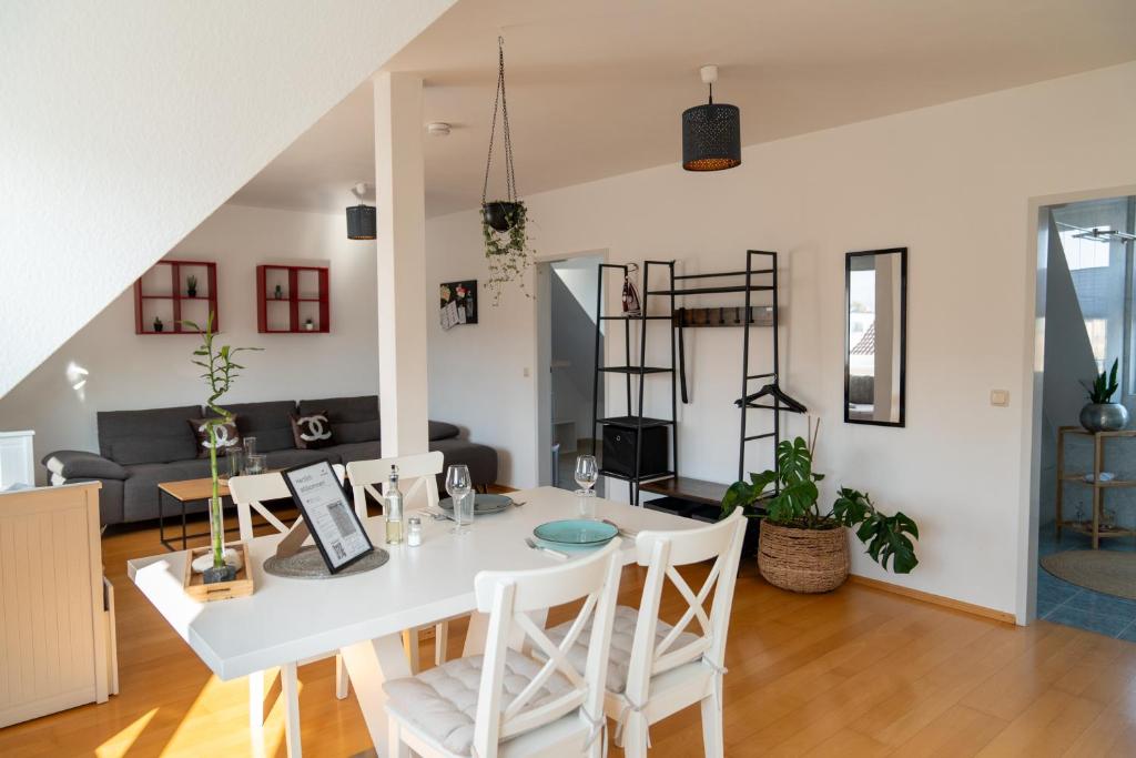 a dining room and living room with a white table and chairs at BRIGHT by Interior Apartments in Kassel