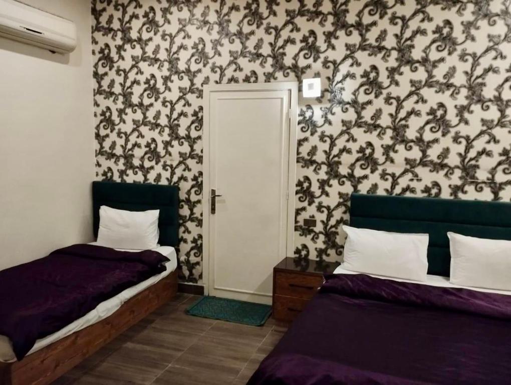 Postel nebo postele na pokoji v ubytování Hotel Richmond Down Town