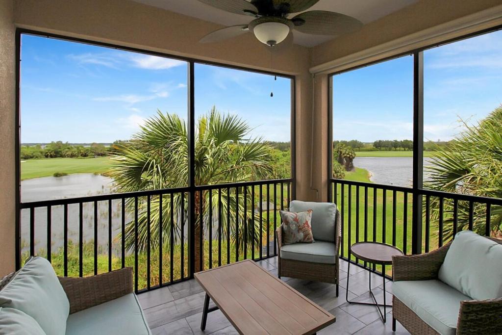 a screened in porch with a view of the water at Lakefront 3rd floor condo at River Strand Golf and Country Club in Bradenton