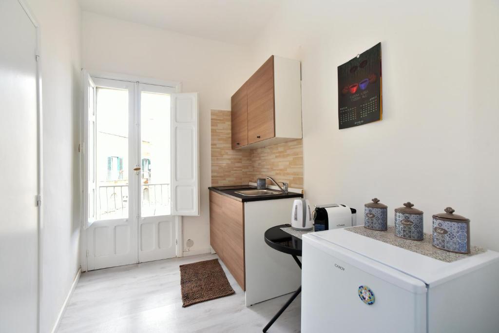 a small kitchen with a sink and a refrigerator at Sud Casa Vacanze in Ragusa