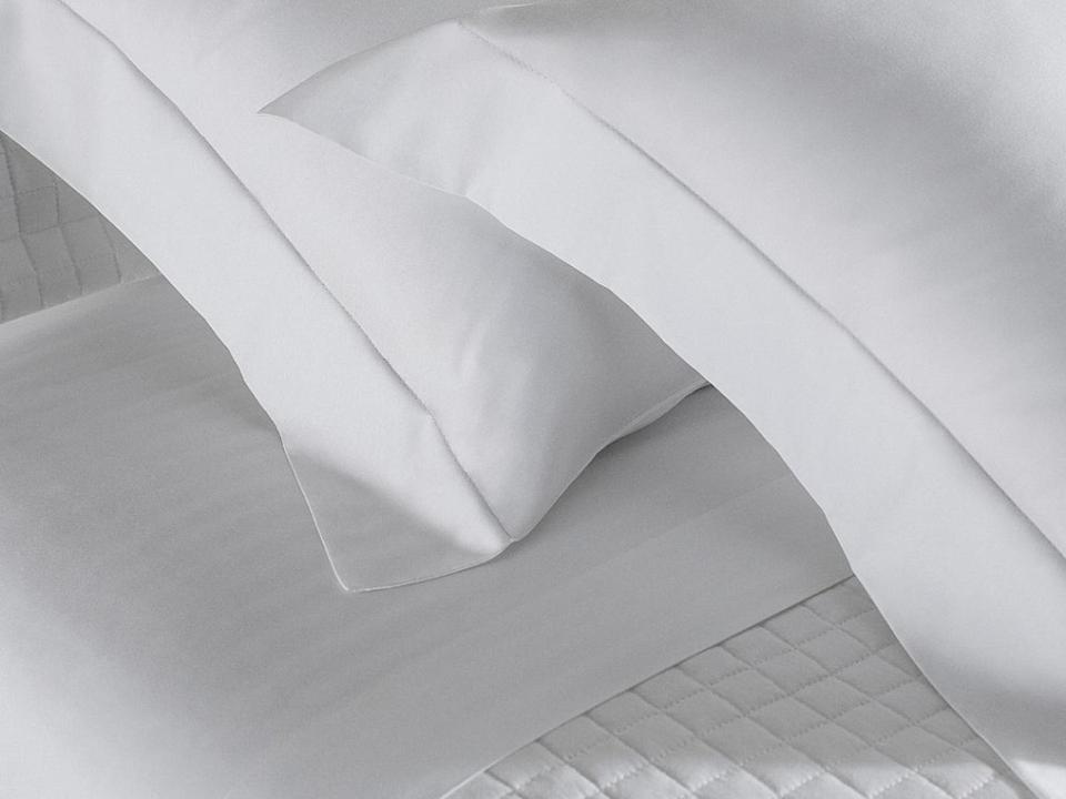 a piece of white paper sitting on top of a bed at hotel in Barreirinhas