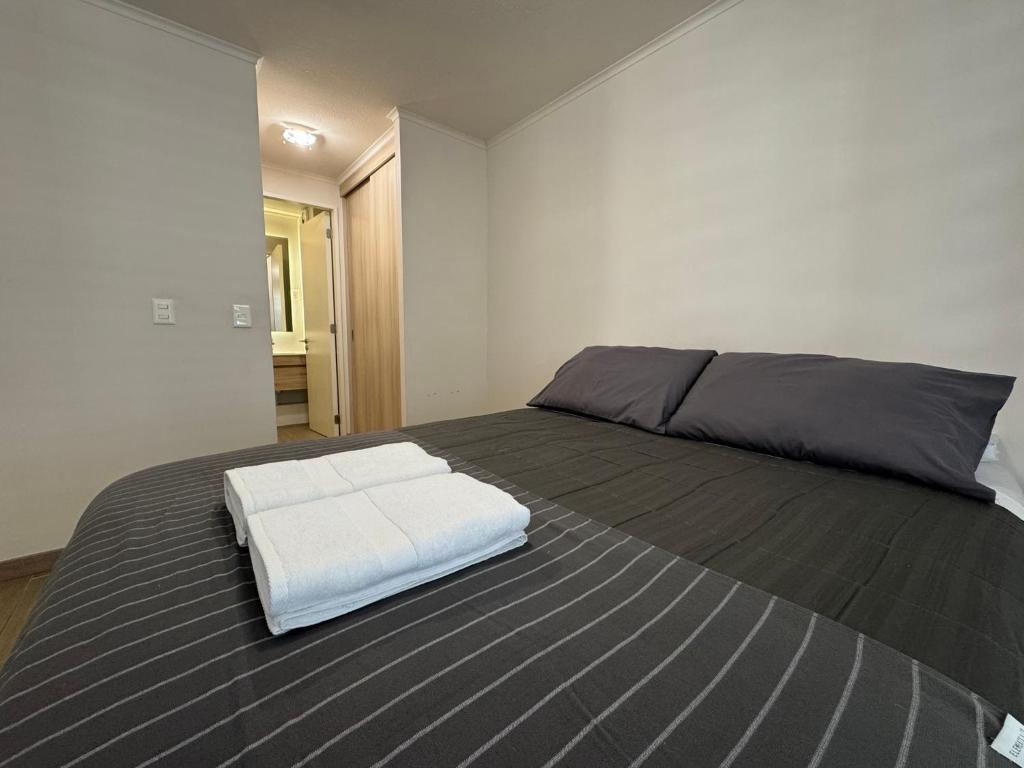 Ένα ή περισσότερα κρεβάτια σε δωμάτιο στο Edificio Claro Solar - Moderno Apartamento Centro Temuco