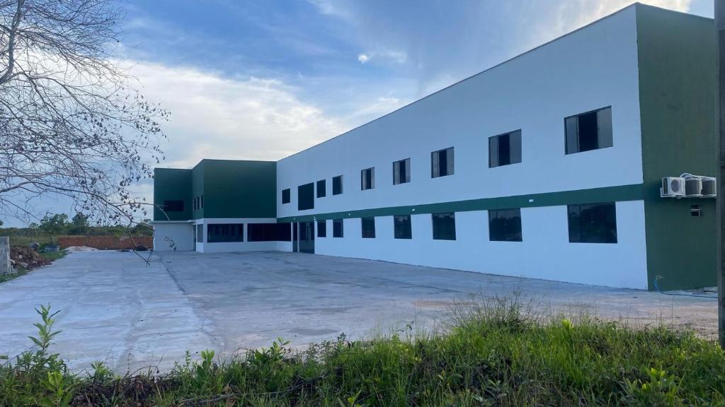 a large white building with a parking lot at Lençóis Prime Hotel in Barreirinhas