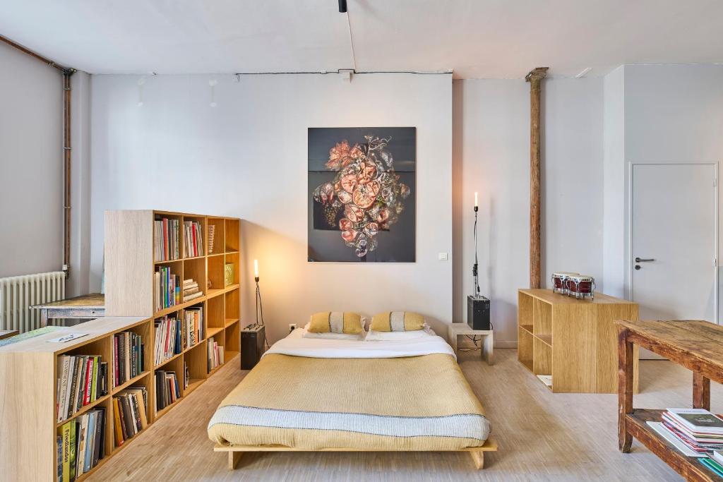 - une chambre avec un grand lit et des étagères dans l'établissement Basilique du Sacré-Cœur, 9 min à pied, à Paris