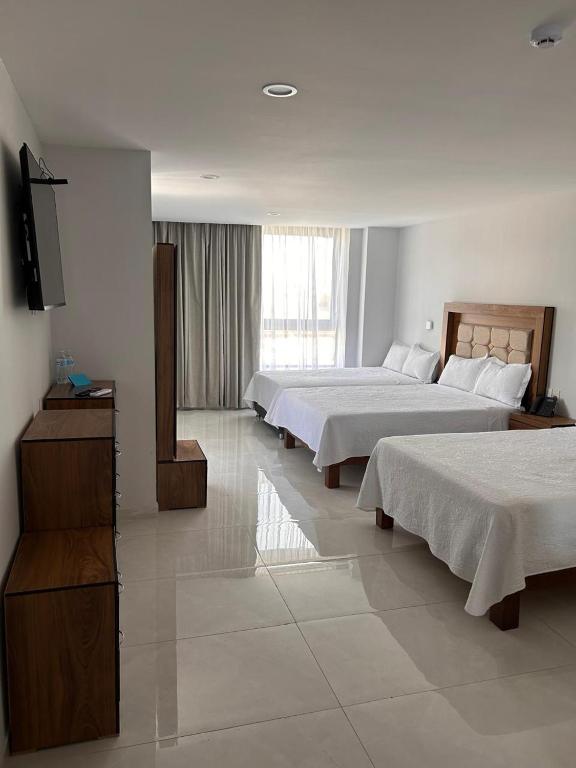 Postel nebo postele na pokoji v ubytování Hotel Concordia
